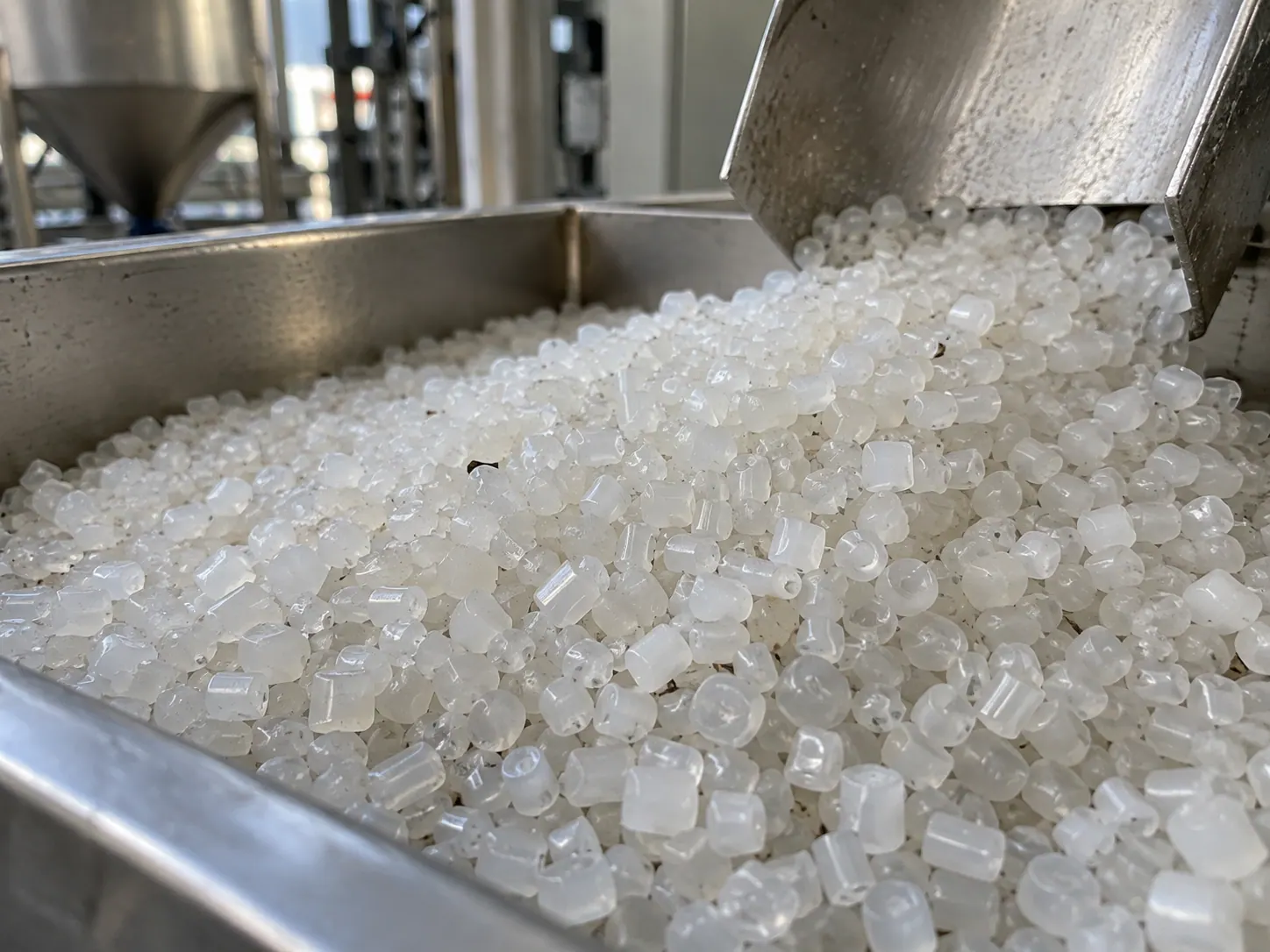 Polymer pellets moving through a stainless handling system